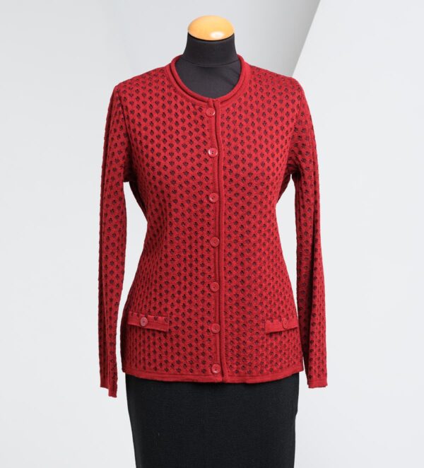 fashionable red knitted cardigan on a stand